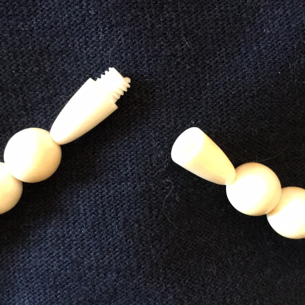 Necklace carved toggle with carved doll